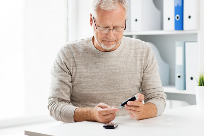 Middle Aged Man Checking Blood Sugar