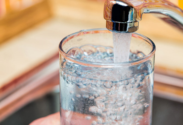 An image of a glass being filled with tap water