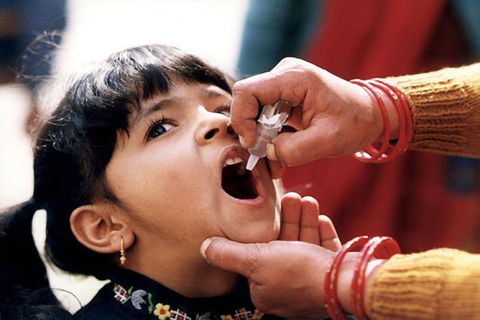 Girl receiving oral vaccine